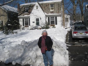 kat in front of snowy house